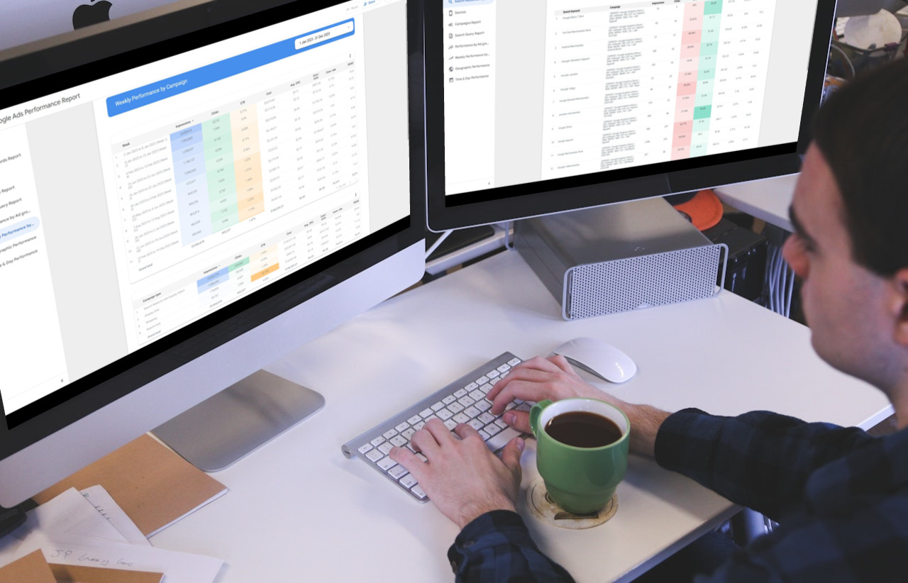 Marketing expert viewing Google ads campaign performance and search keyword report on two screens